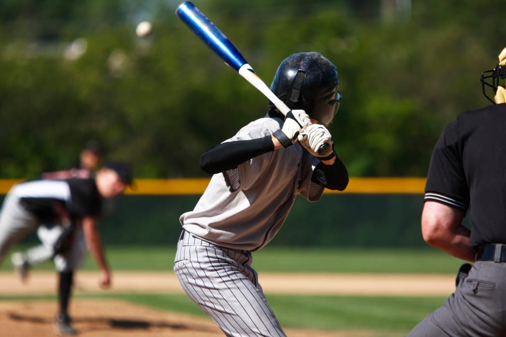 View of baseball batter from behind the catcher as they hit