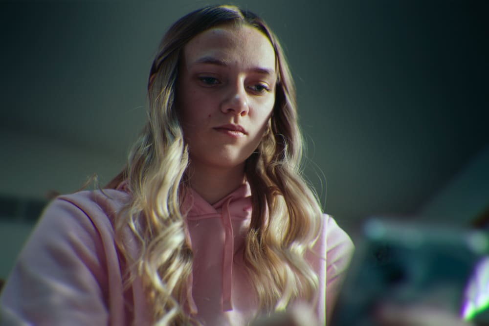 Lauryn Licari looks down at a cellphone