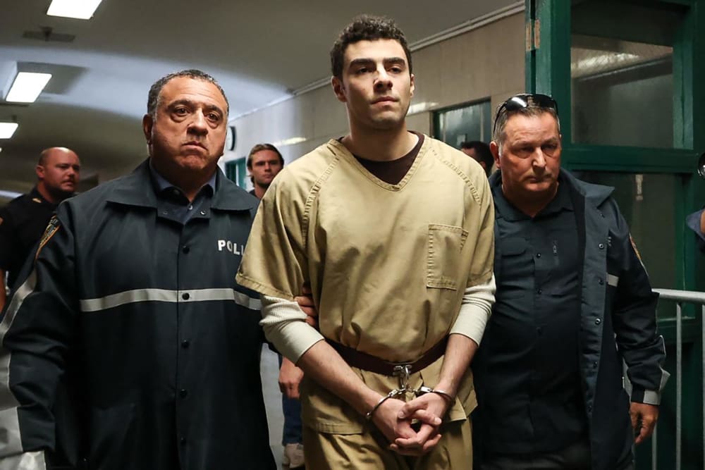 Luigi Mangione, accused of the murder of United Healthcare CEO Brian Thompson, is escorted by police as he arrives at court in New York City on September 16, 2025.