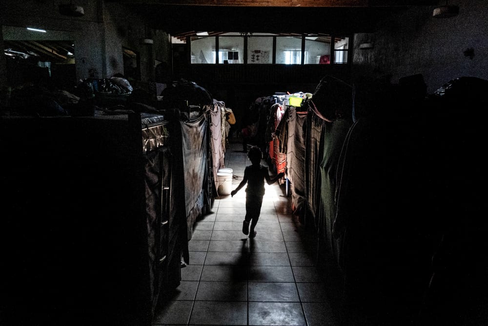 A migrant child plays between bunk beds at the Templo Embajadores De Jesus shelter in Tijuana, Mexico, on March 23, 2022.