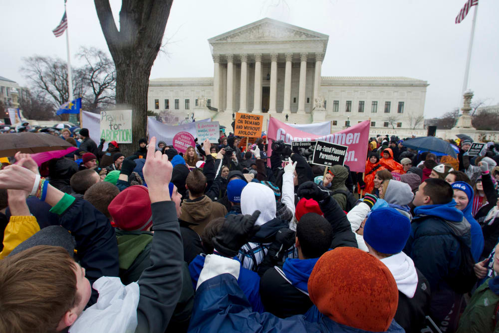 Anti-abortion and abortion rights supporters stand face to face in front of the Supreme Court in Washington, Monday, Jan. 23, 2012, during the annual March For Life rally. (AP Photo/Manuel Balce Ceneta)