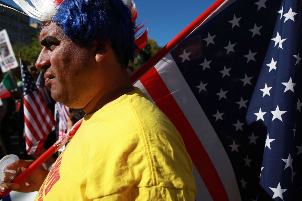A protestor wearing a red, white and blue mohawk wig, rallies with civil liberties, immigrant rights and equality groups that attended a May Day protest at in New York City on May 1, 2013.