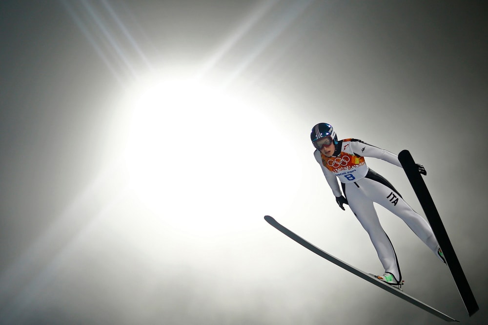 Italy's Evelyn Insam soars through the air in her trial jump during the women's ski jumping individual normal hill event of the Sochi 2014 Winter Olympic Games, at the RusSki Gorki Ski Jumping Center in Rosa Khutor, February 11, 2014.