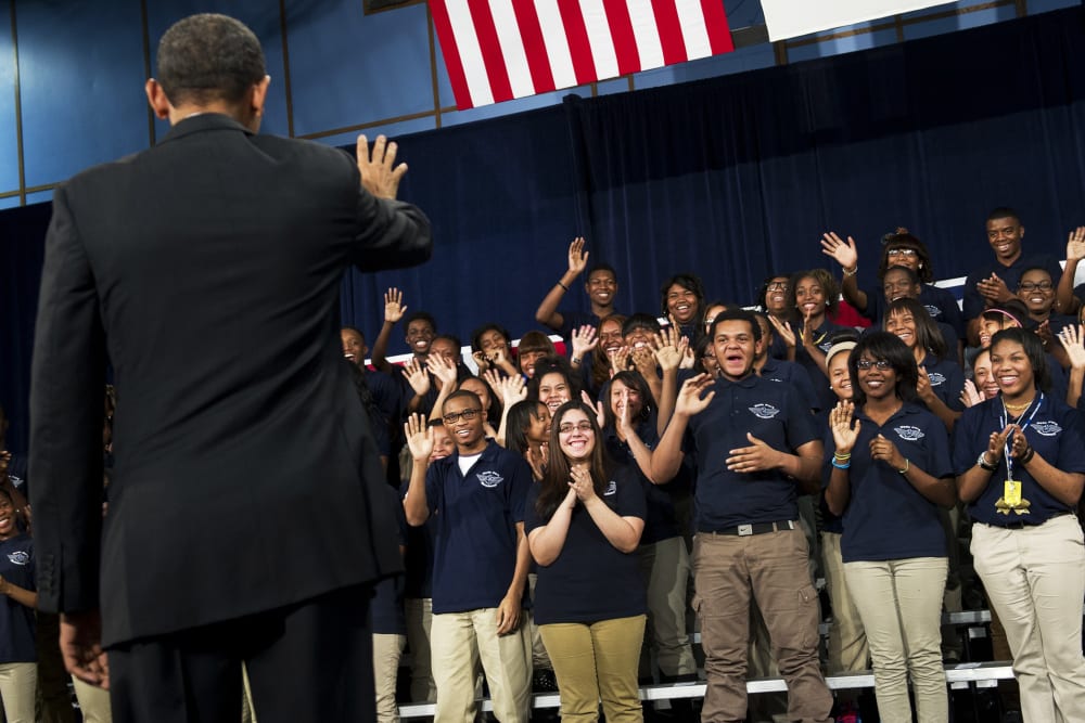 Barack Obama waves to students prior to speaking at Hyde Park Academy in Chicago, Feb. 15, 2013.