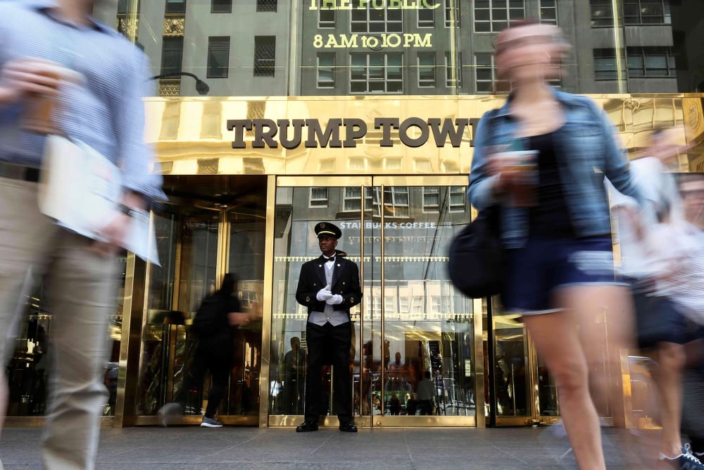 A doorman stands as people walk past the Trump Tower in N.Y. on May 23, 2016. (Photo by Carlo Allegri/Reuters)
