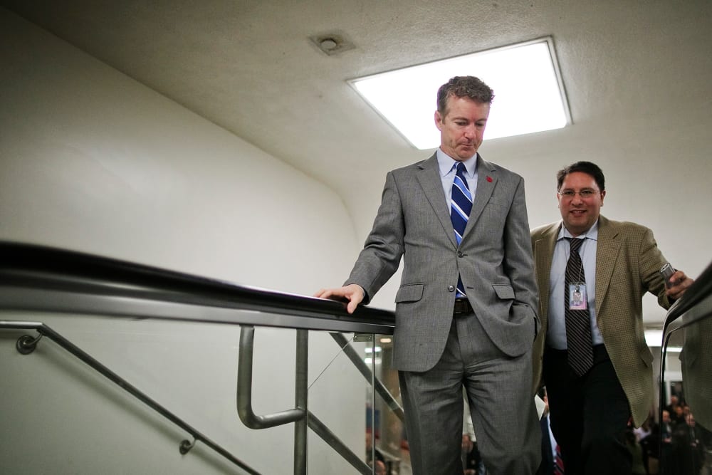 U.S. Senator Rand Paul talks to a reporter as he arrives for the weekly Republican caucus luncheon at the U.S. Capitol, Feb. 4, 2014.