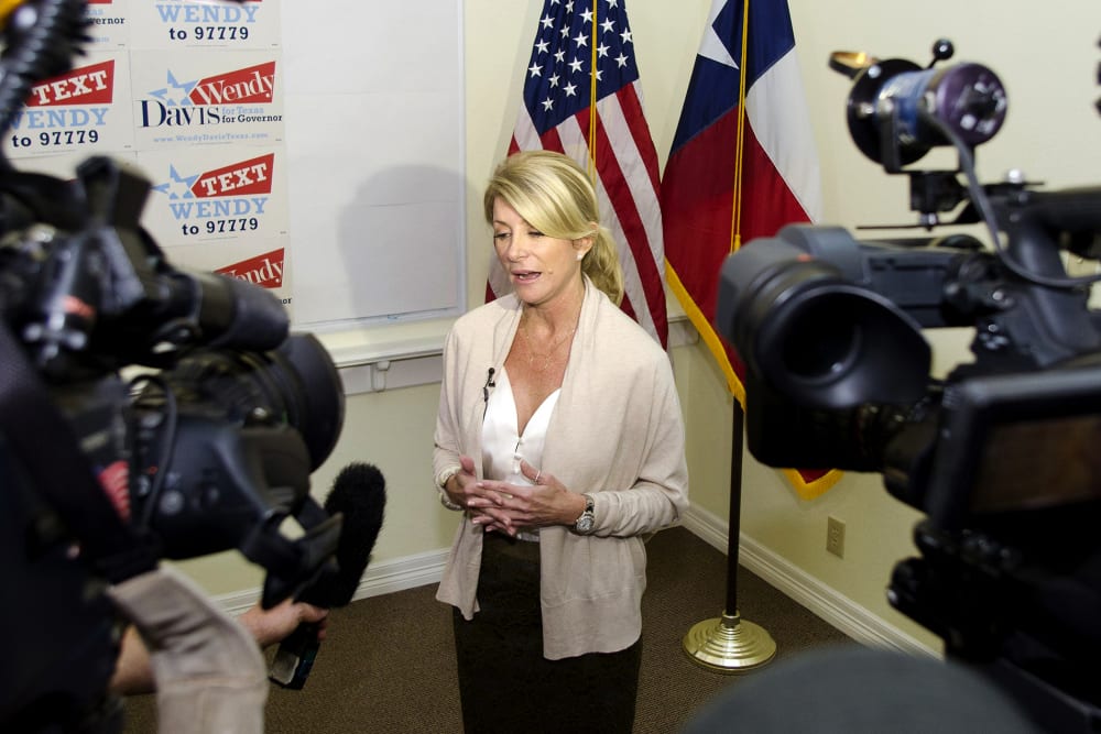Texas Democrat State Senator Wendy Davis answers media questions during the opening of her gubernatorial campaign headquarters in Fort Worth, Texas, Dec. 14, 2013.