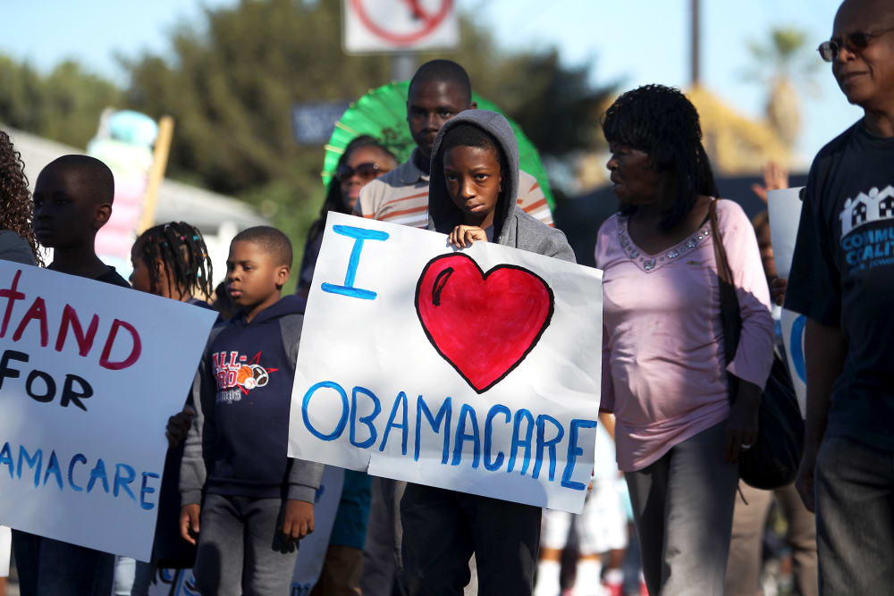 Supporters of the Affordable Care Act march in the 29th annual Kingdom Day Parade in Los Angeles, Jan. 20, 2014.