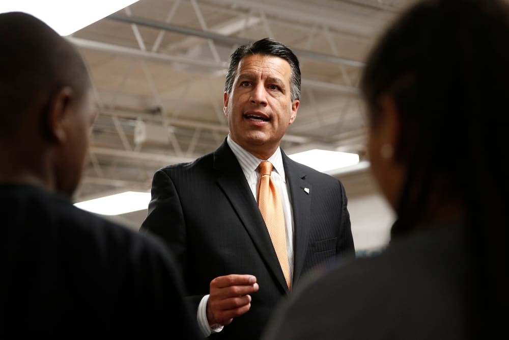 Nevada Governor Brian Sandoval holds a signing ceremony for Senate Bill 432, which allocates millions of dollars for low performing schools, June 3, 2015, in Las Vegas. (Photo by John Locher/AP)