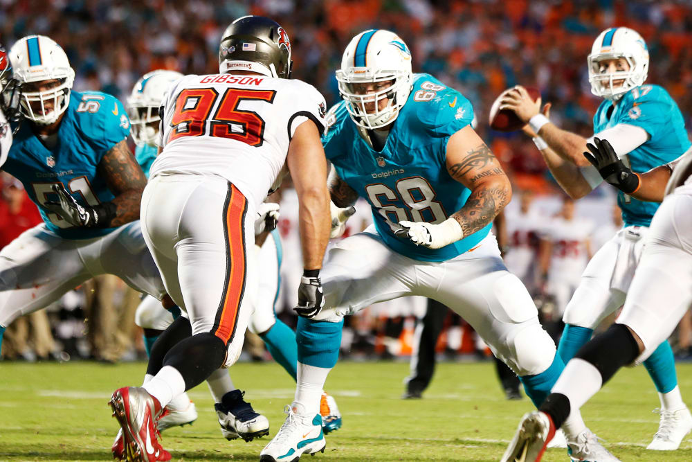 Richie Incognito #68 of the Miami Dolphins battles Gary Gibson #95 of the Tampa Bay Buccaneers during a preseason game, Aug. 24, 2013.