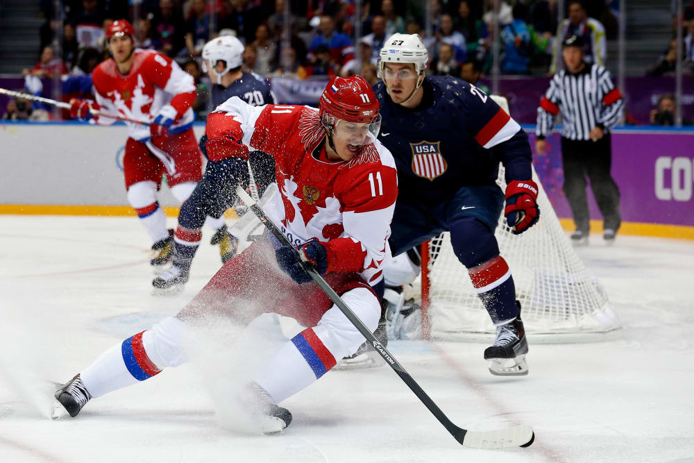 Russia's Yevgeni Malkin (L) spins away from Team USA's Ryan McDonagh during the first period of their men's preliminary round ice hockey game, Feb. 15, 2014, in Sochi, Russia.