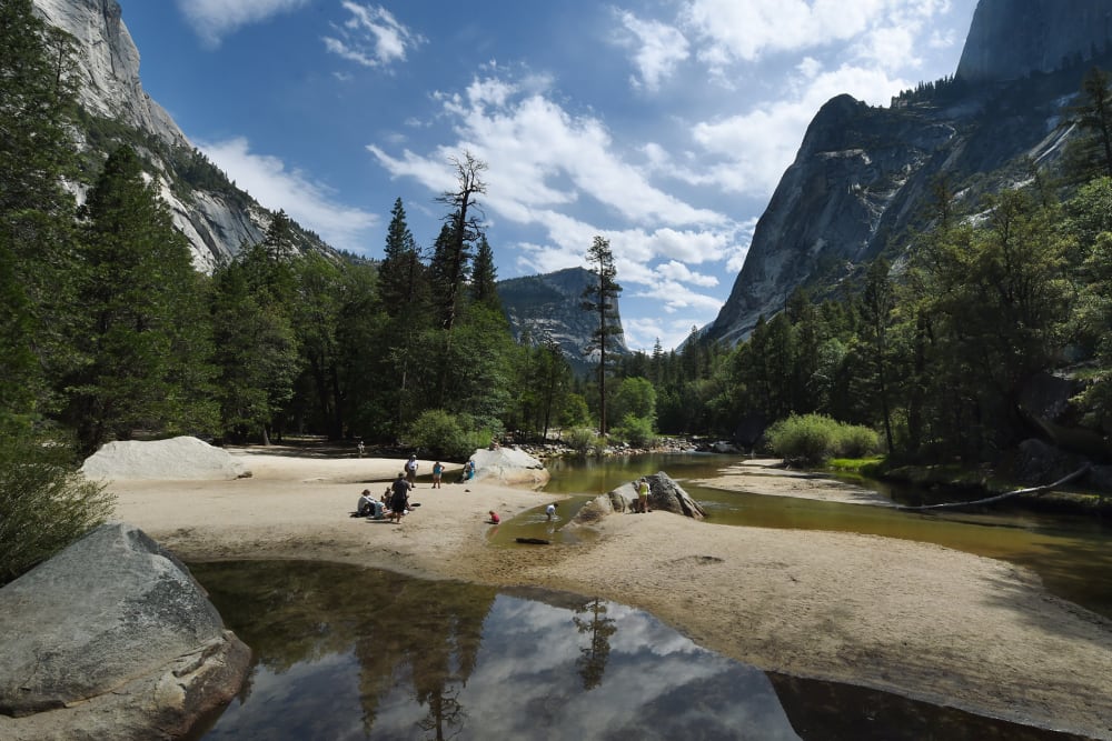 People picnic on the exposed sandy bottom of Mirror Lake that is normally underwater and used by visitors to photograph reflections of the Half Dome rock monolith, June 4, 2015, at Yosemite National Park in Calif. (Photo by Mark Ralston/AFP/Getty)