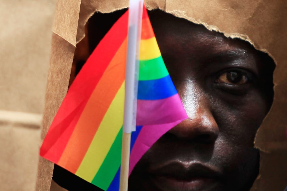An asylum seeker from Uganda covers his face with a paper bag in order to protect his identity as he marches with the LGBT Asylum Support Task Force during the Gay Pride Parade in Boston, Mass. on June 8, 2013.