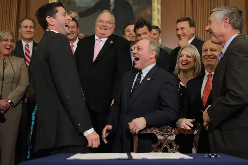 Speaker of the House Paul Ryan shares a laugh with Republican members of Congress after signing legislation to repeal the Affordable Care Act, also known as Obamacare, and to cut off federal funding of Planned Parenthood.