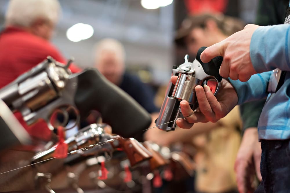 An attendee handles a revolver in the Sturm, Ruger & Co., Inc. booth on the exhibition floor of the 144th National Rifle Association (NRA) Annual Meetings and Exhibits in Nashville, Tenn. on April 11, 2015. (Photo by Daniel Acker/Bloomberg/Getty)
