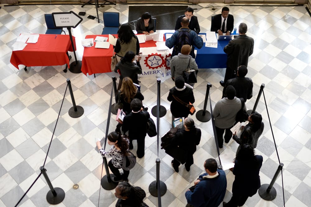 Job seekers wait to speak with employers at a job fair in the Brooklyn borough of New York, N.Y., on April 11, 2014. (Photo by Andrew Gombert/EPA)