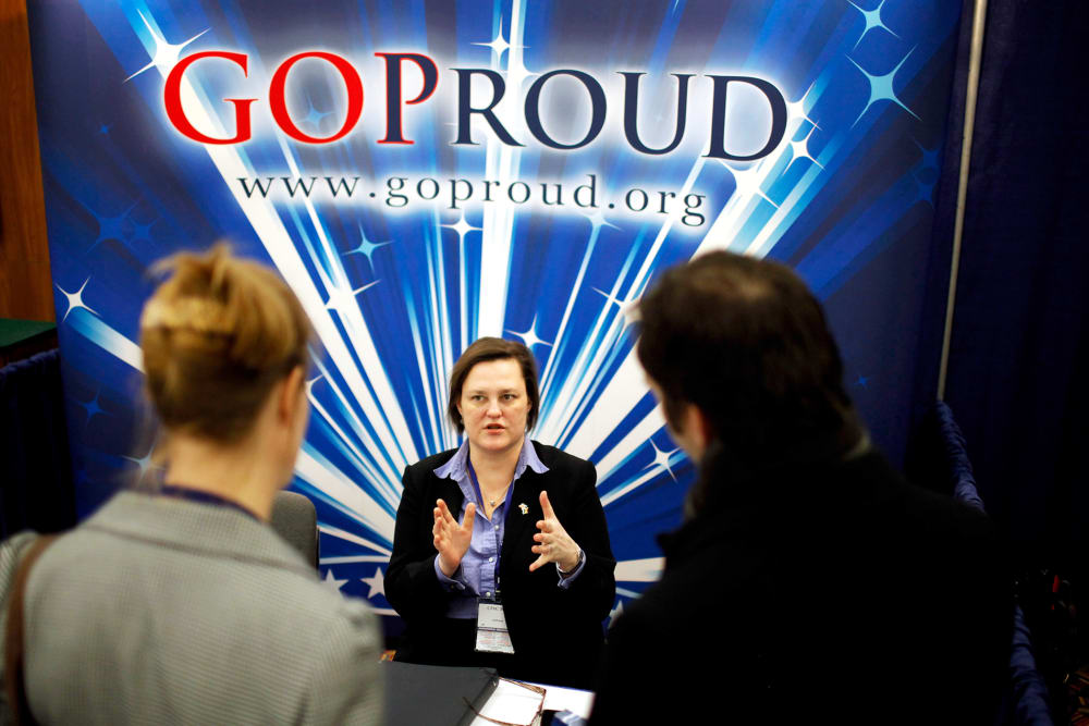 Participants talk with a representatives from GOProud, an organization that represents gay conservatives and their allies, at the 2011 CPAC in Washington, DC.