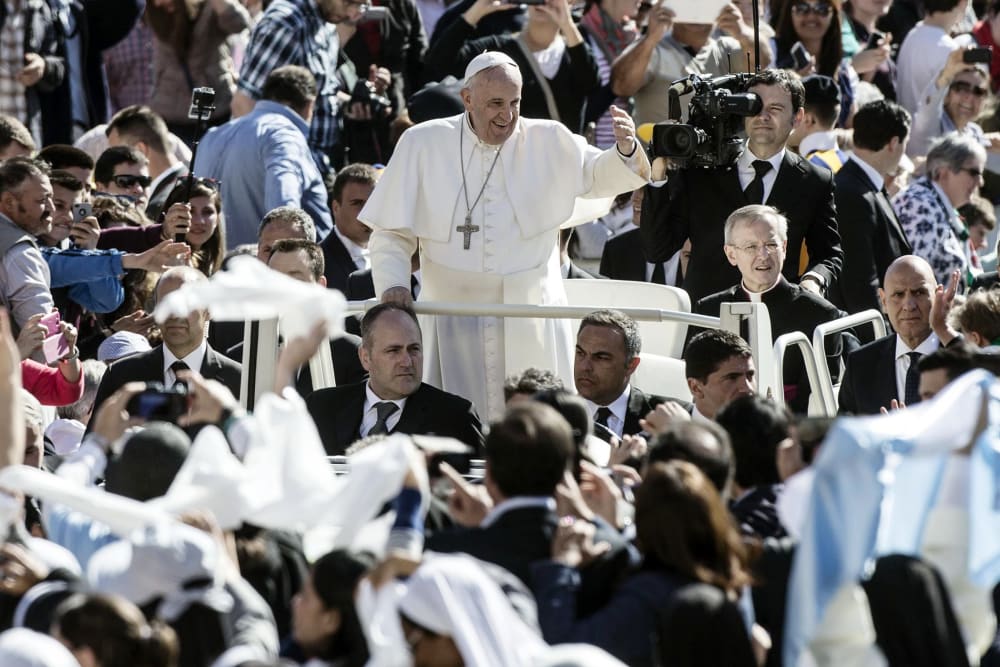Pope Francis followers as he arrives in St. Peter's Square for his weekly general audience, in the Vatican City on April 22, 2015.