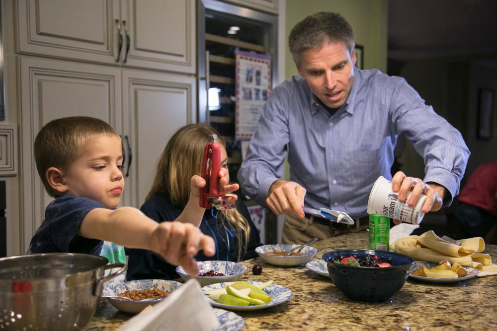 Carl Krawitt makes dinner for his son Rhett, 6, left, and daughter Annesley, 8, center, in their home in Corte Madera, Calif. on Jan. 28, 2015.