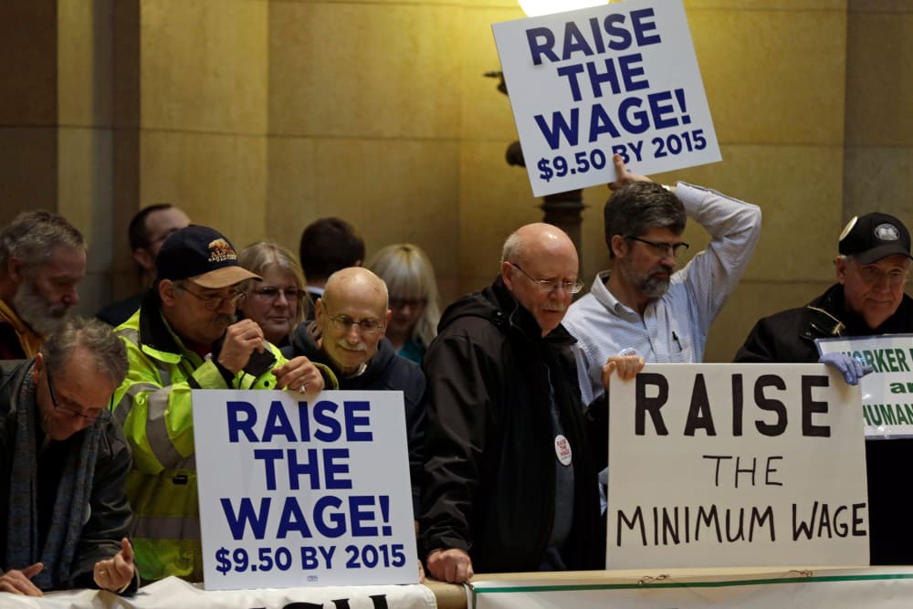 Demonstrators rally at the state Capitol, calling for lawmakers to raise the minimum wage, February 25, 2014, in St. Paul, Minn.
