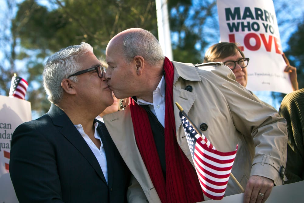 Robert Roman and Claus Ihlemann, of Virginia Beach, celebrate a ruling that declared Virginia's same-sex marriage ban unconstitutional on Feb. 14, 2014, in Norfolk, Va.