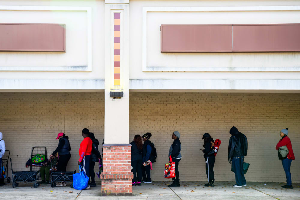 Furloughed federal workers wait in line at a Capital Area Food Bank distribution site.