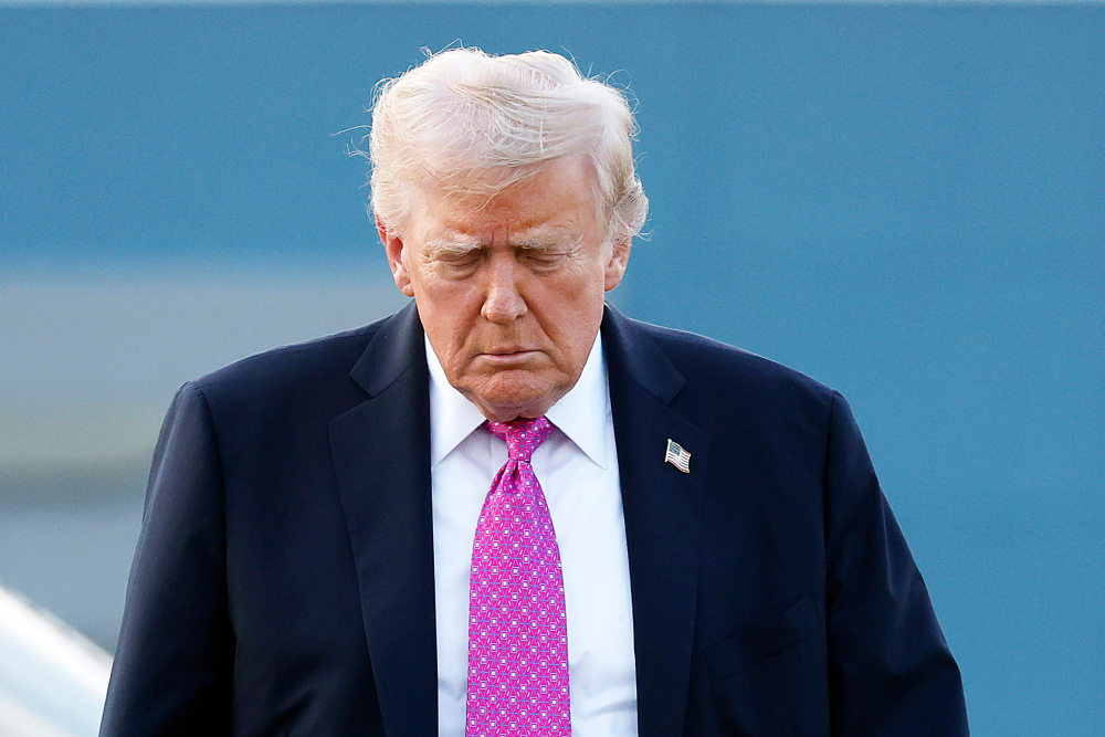 U.S. President Donald Trump looking down.