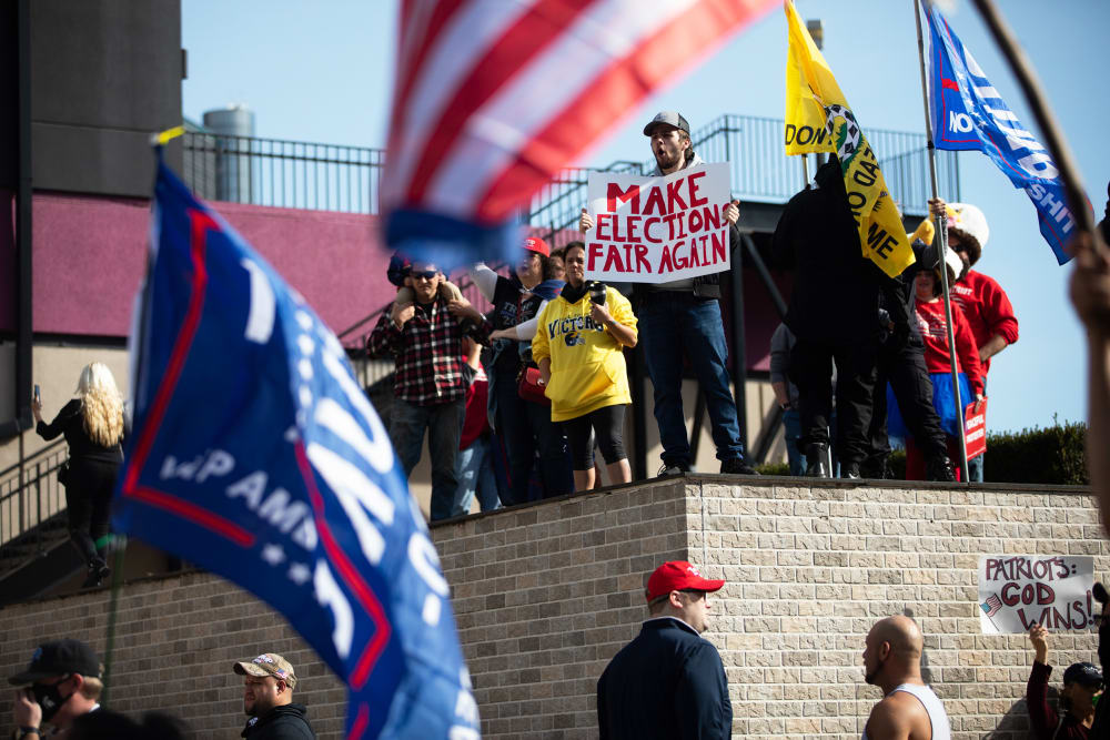 Demonstrators hold signs at a pro-Trump protest during the 2020 Presidential election in Detroit.