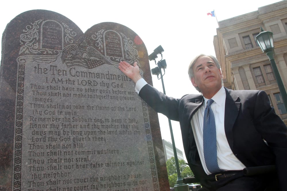 Texas Attorney General Greg Abbott attends a press conference celebrating the U.S. Supreme Court decision that allows a Ten Commandments monument to stand outside the Texas State Capitol in Austin, Texas on Jun. 27, 2005 (Photo by Jana Birchum/Getty).