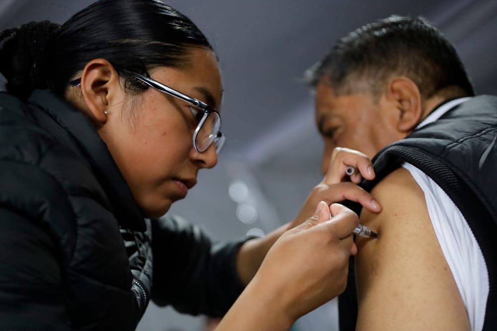 A health worker administers a vaccine during a mass vaccination campaign in Mexico City, Mexico.