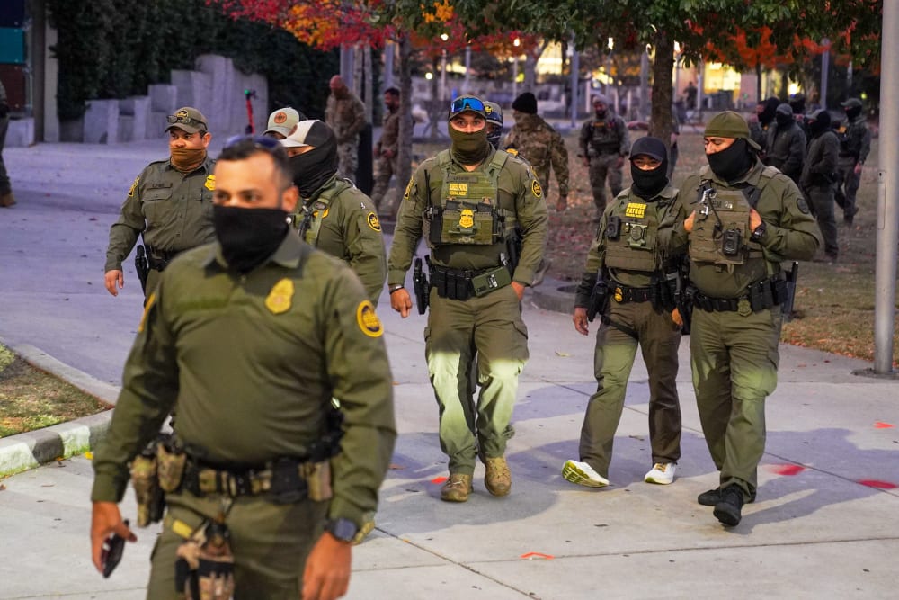 Federal Agents walk through a park in Downtown Charlotte, NC.