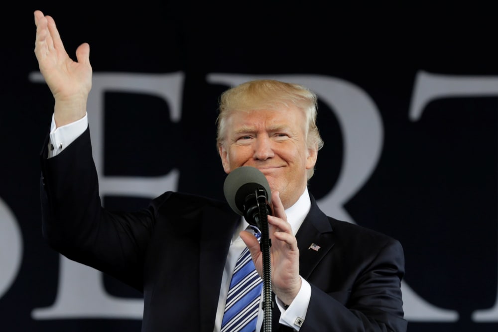 Image: President Donald Trump waves before delivering keynote address
