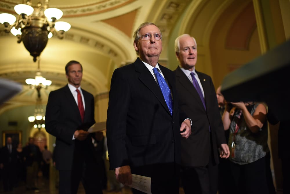 Then-Senate Minority Leader Mitch McConnell (C) (R-KY) arrives to answer questions following the weekly Republican policy luncheon at the U.S. Capitol on Nov. 13, 2014 in Washington, D.C. (Photo by Win McNamee/Getty)