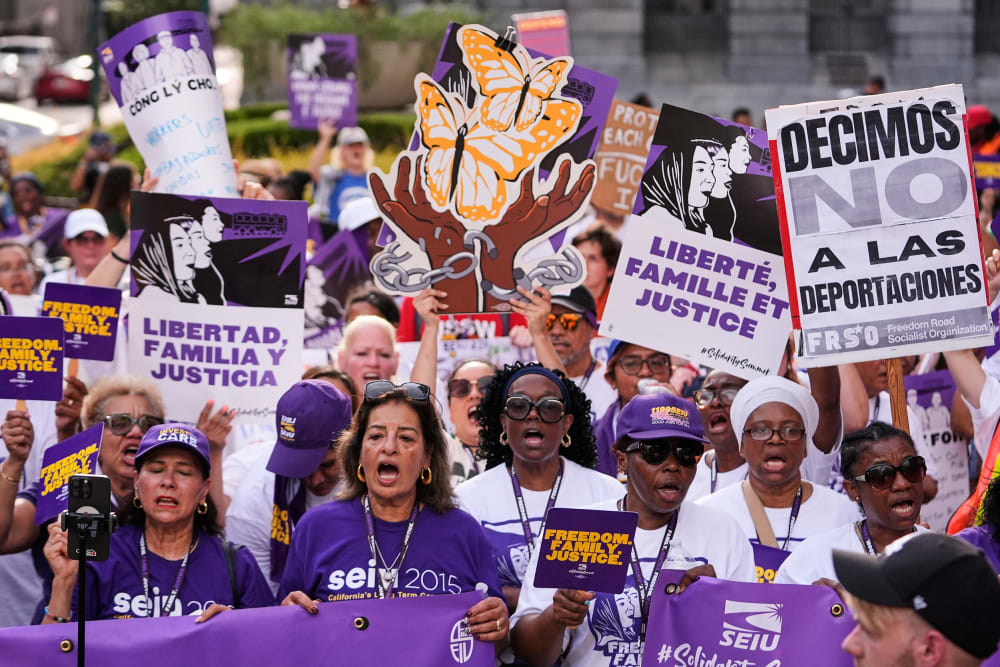 People protest ICE detentions at a demonstration organized by the Service Employees International Union in New Orleans.
