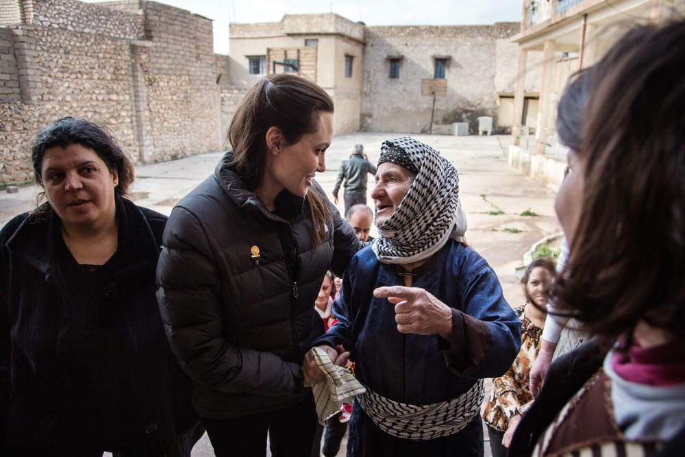 Angelina Jolie meets meets displaced Iraqis who are members of the minority Christian community, living in an abandoned school, on Jan. 26, 2015 in Al Qosh, Iraq. (Photo by Andrew McConnell/UNHCR/Getty)