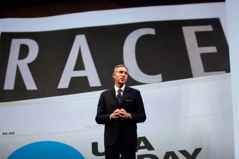 Starbucks Corp Chief Executive Howard Schultz, pictured with images from the company's new "Race Together" project behind him, speaks during the company's annual shareholder's meeting in Seattle, Washington March 18, 2015. (Photo by David Ryder/Reuters)