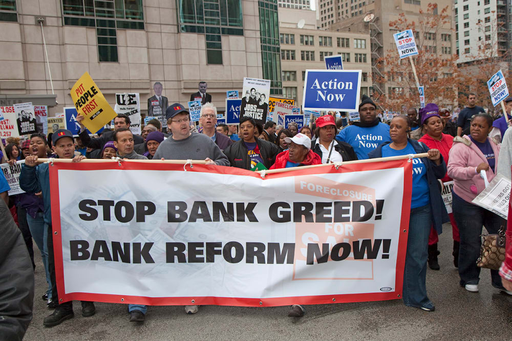 Unions, religious groups, and community organizations in Chicago rally outside the conference of the American Bankers Association.