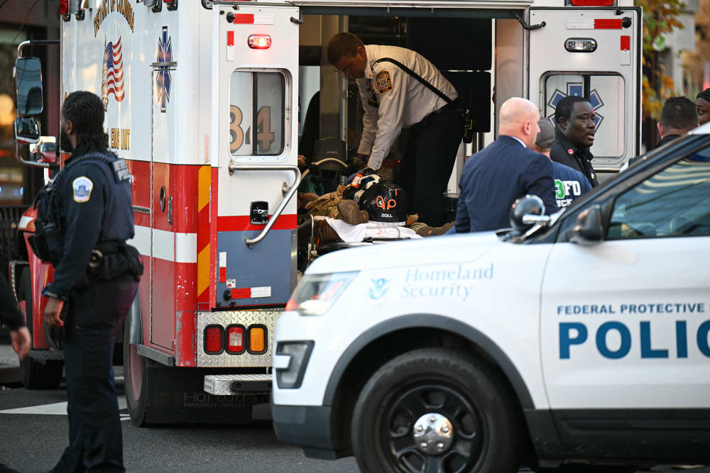 An unidentified man in military fatigues lies on a stretcher inside an ambulance in downtown Washington, D.C.