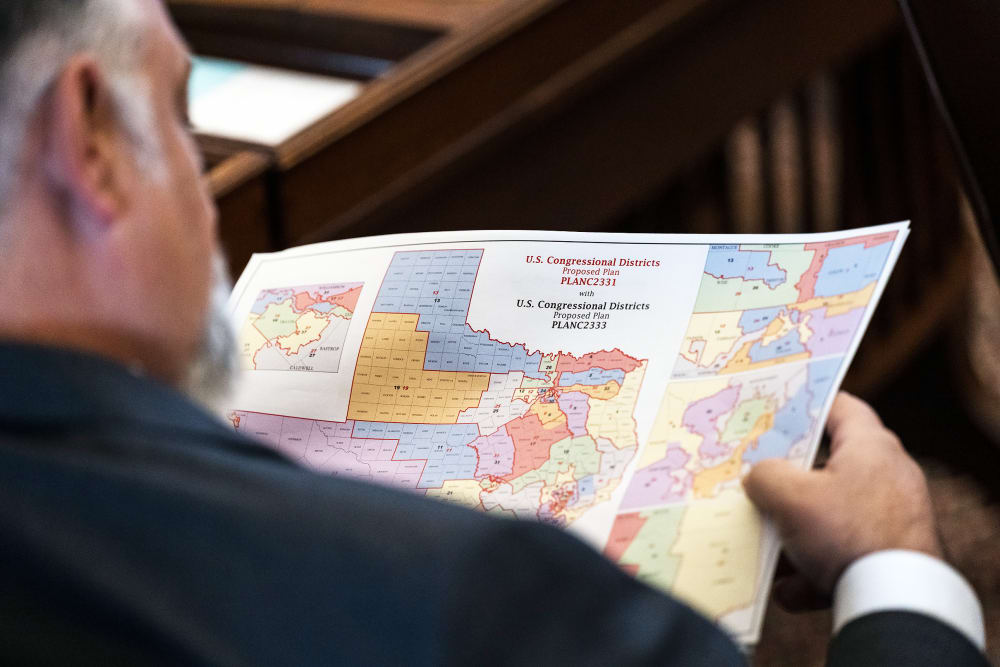 A State Representative reviews a map of proposed Texas congressional redistricting.