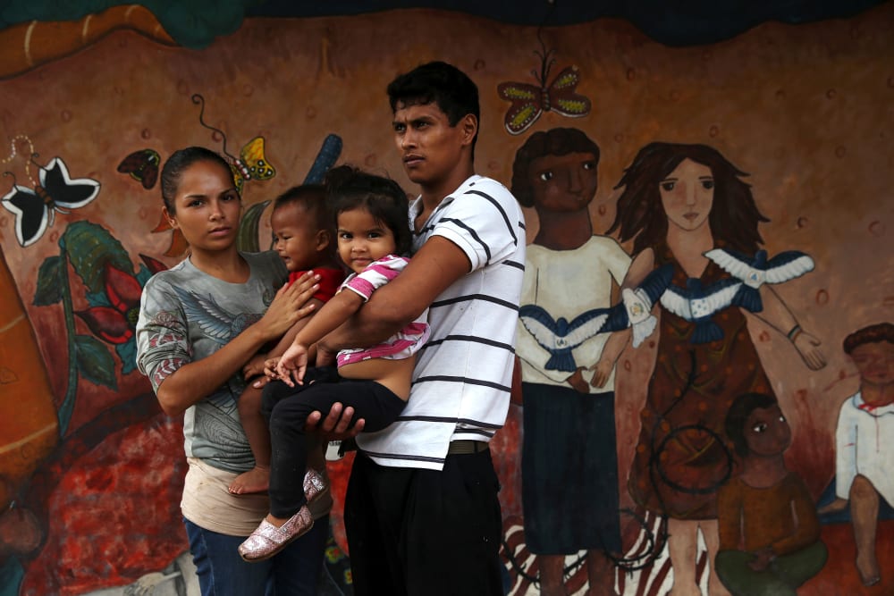 A family of immigrants arrives from Honduras to a shelter for undocumented immigrants on September 15, 2014 in Tenosique, Mexico.