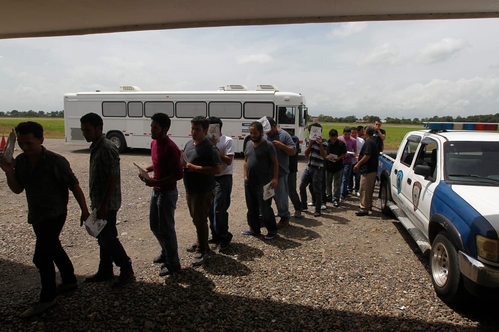 Deportees line up at the Care Center for Returning Migrants (CAMR) after arriving on an immigration flight from the U.S., at the international airport in San Pedro Sula