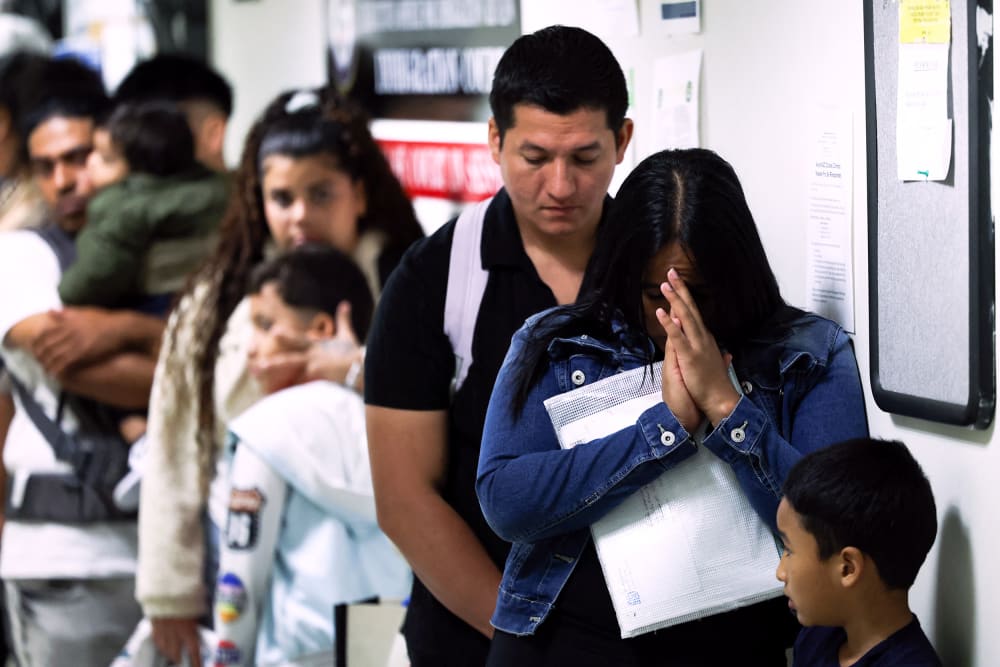 People wait in line before their hearings at the New York Federal Plaza Immigration Court in New York City.