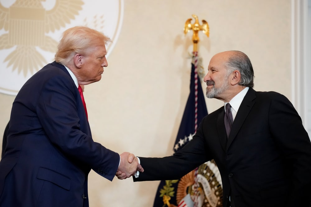 President Donald Trump shakes hands with Secretary of Commerce Howard Lutnick in Tokyo, Japan.