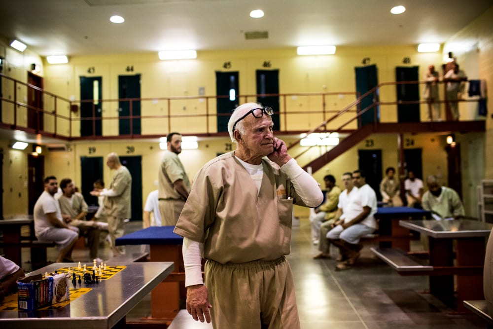 A prisoner at Rhode Island's John J. Moran Medium Security Prison walks through his cell block, Dec. 10, 2013.