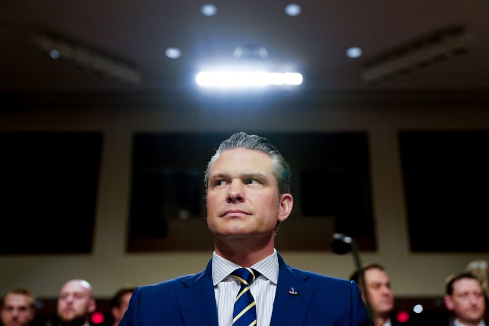 A light shines above Pete Hegseth, US secretary of defense, during a Senate Armed Services Committee hearing in Washington, D.C.