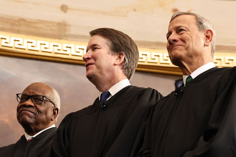 Associate Supreme Court Justices Clarence Thomas and Brett Kavanaugh and Supreme Court Chief Justice John Roberts during Donald Trump's inauguration in the Capitol.