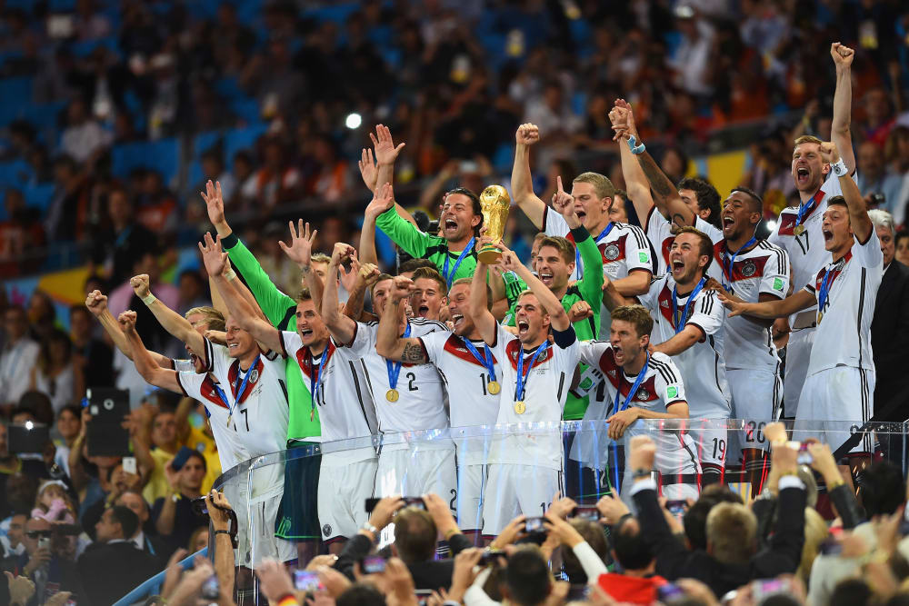 Philipp Lahm of Germany lifts the World Cup trophy after defeating Argentina 1-0 in extra time during the 2014 FIFA World Cup Brazil Final match between Germany and Argentina at Maracana on July 13, 2014 in Rio de Janeiro, Brazil. (Matthias Hangst/Getty)