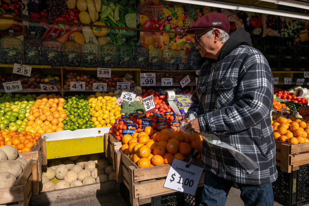 A man walks by a food market in New York City.