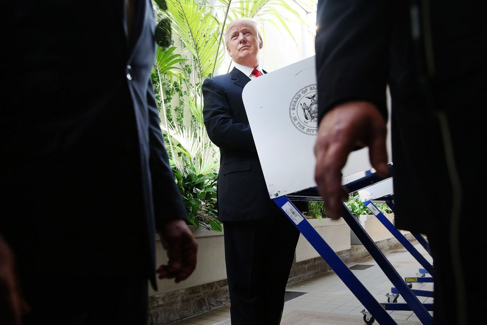 Security agents stand close as Republican Presidential candidate Donald Trump votes at his local polling station in New York's primary on April 19, 2016 in New York City. (Photo by Spencer Platt/Getty)