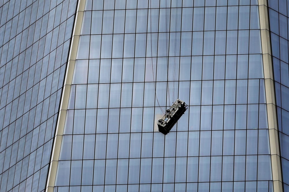 A scaffold carrying two workers hangs 69 floors up at One World Trade Center on Nov. 12, 2014 in New York City.